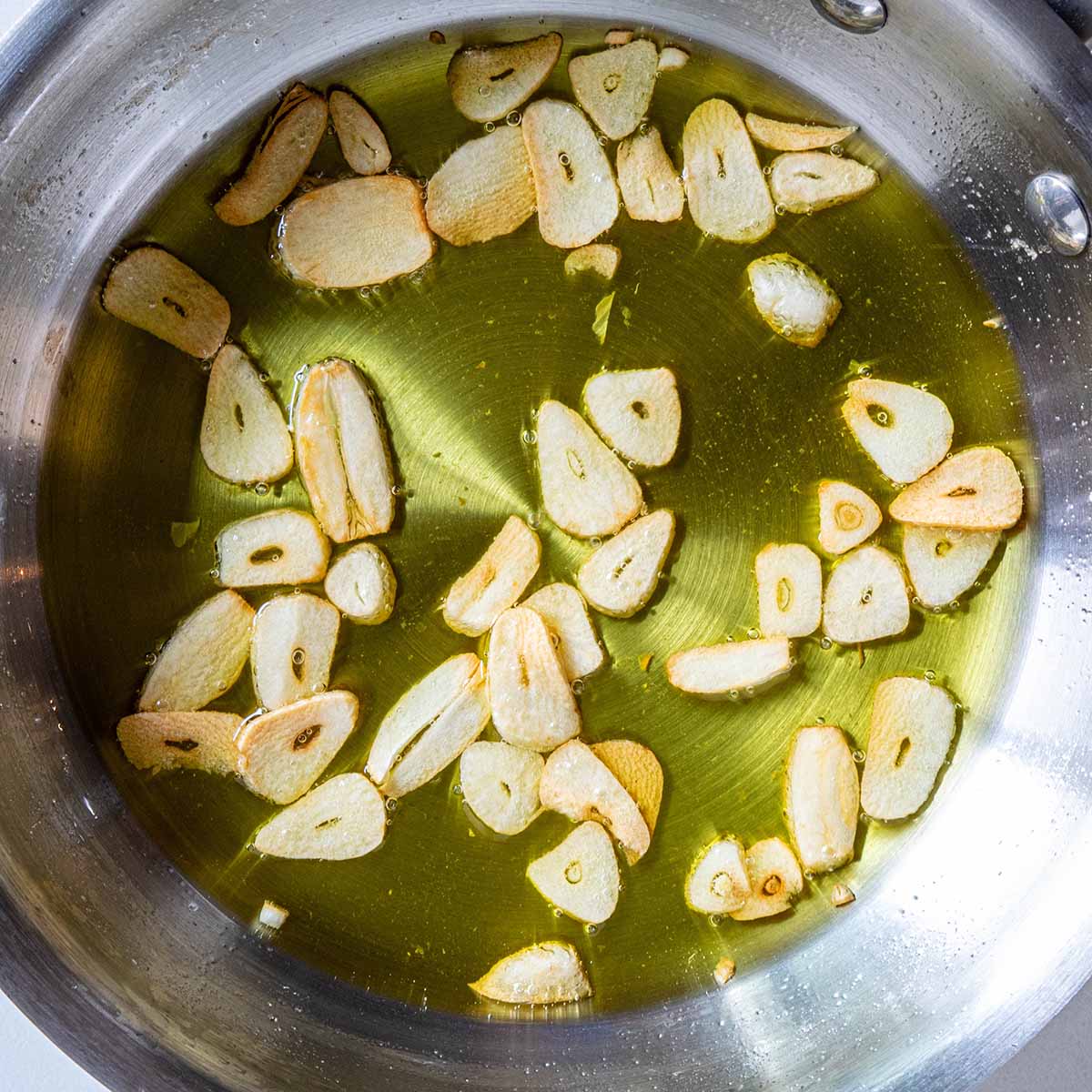 Garlic chips fried in a pan of shallow oil for a soup garnish.
