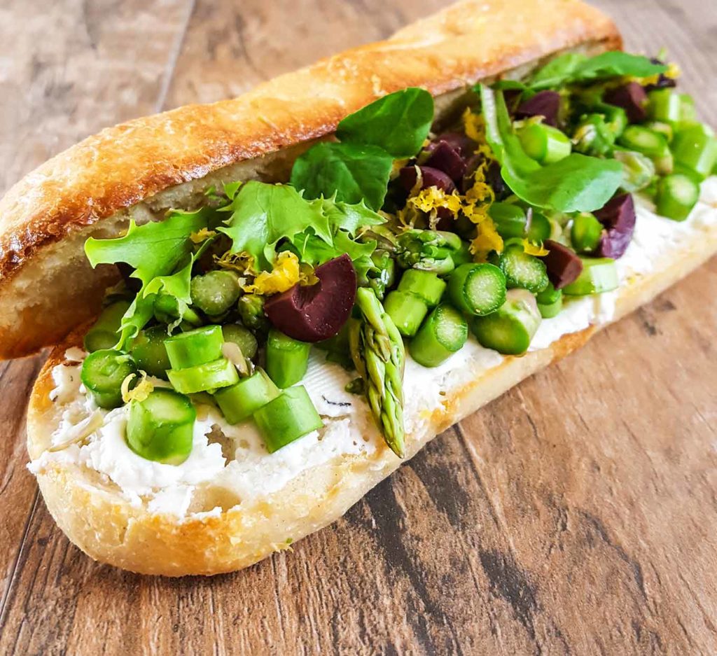 Lunch recipes - a picnic sandwich that holds until lunch time. Raw, crisp and slightly sweet asparagus from the farmers market stays crisp all day, even in this make-ahead version.