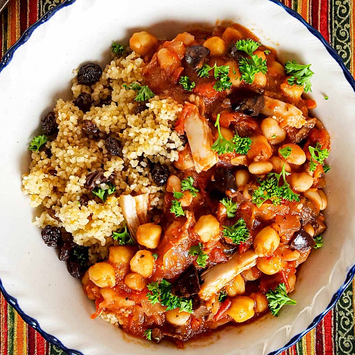 Moroccan chickpea stew with tomatoes, chicken, olives, and a raisin cinnamon couscous.