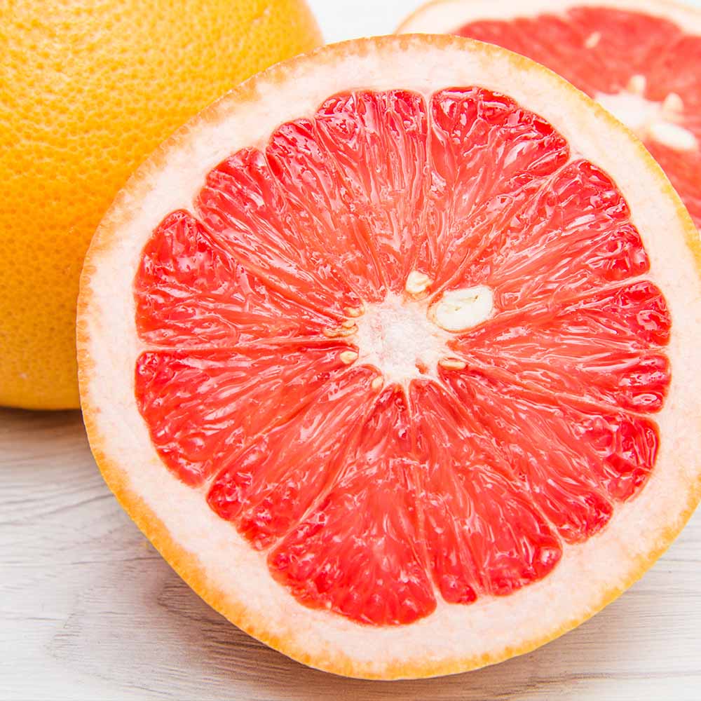 A ruby red grapefruit variety cut on half to show the red flesh