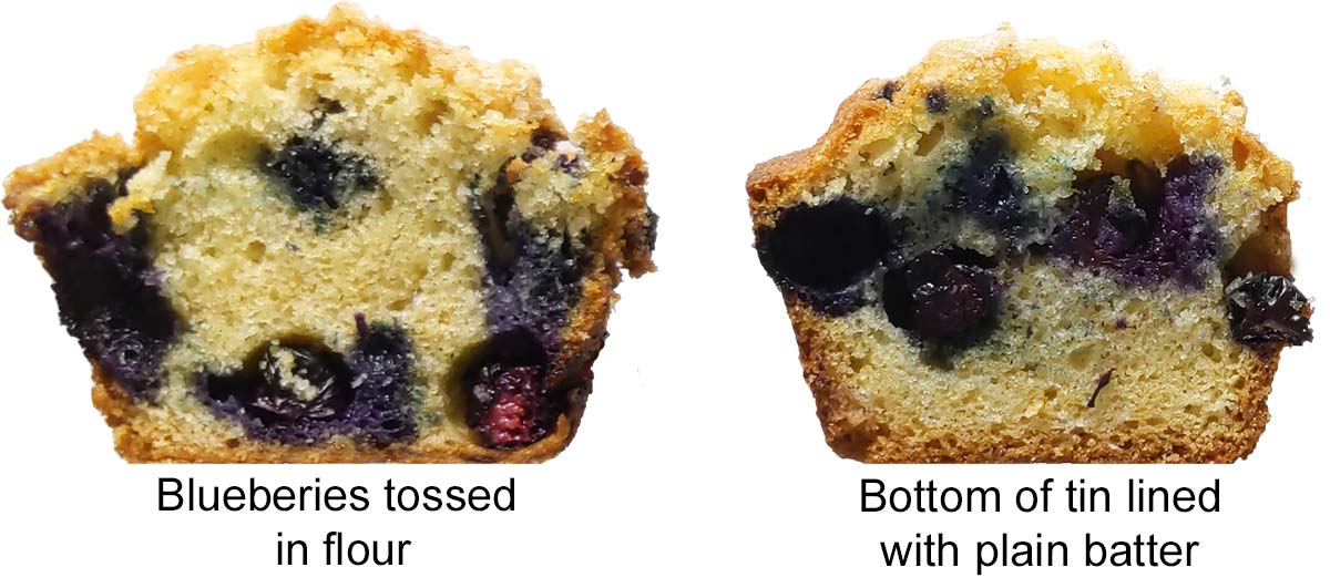 Two blueberry muffins, side by side, one with blueberries on the bottom, the other had ¼ of the tin filled with plain batter.