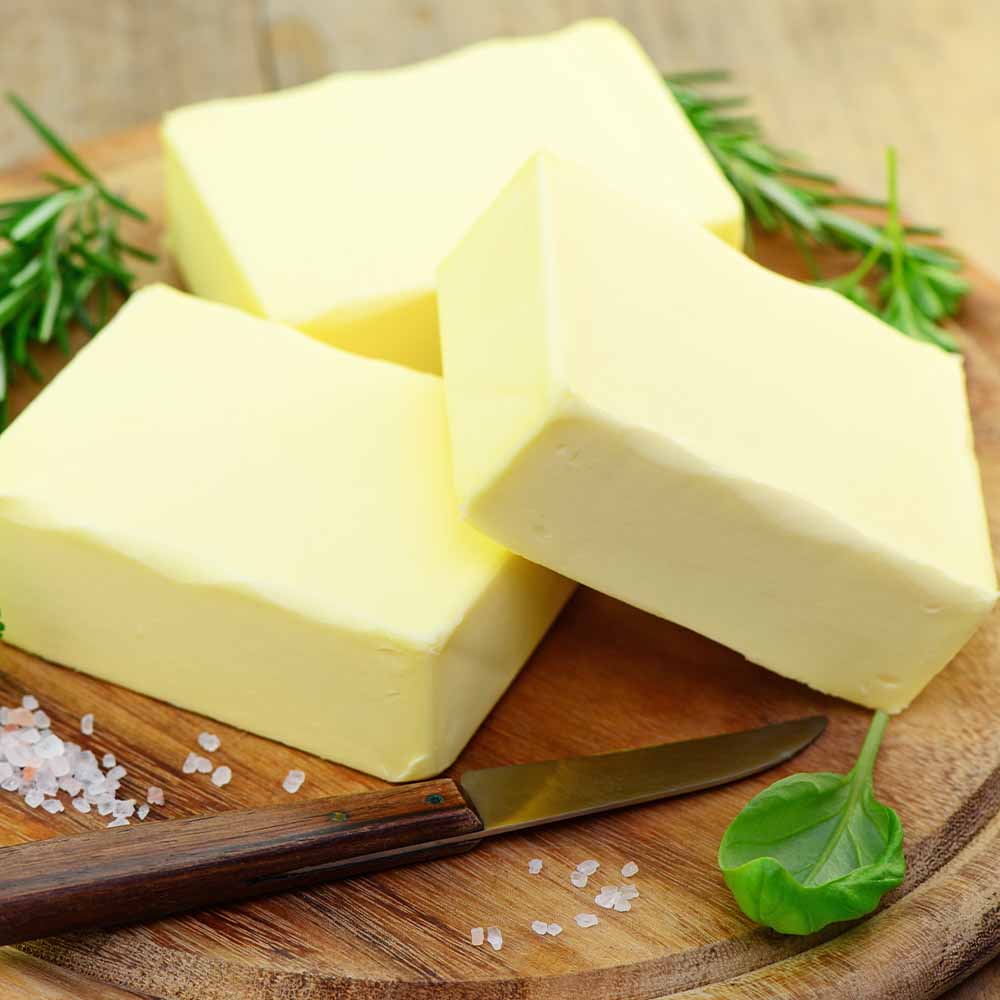 Slices of butter on a wooden serving board