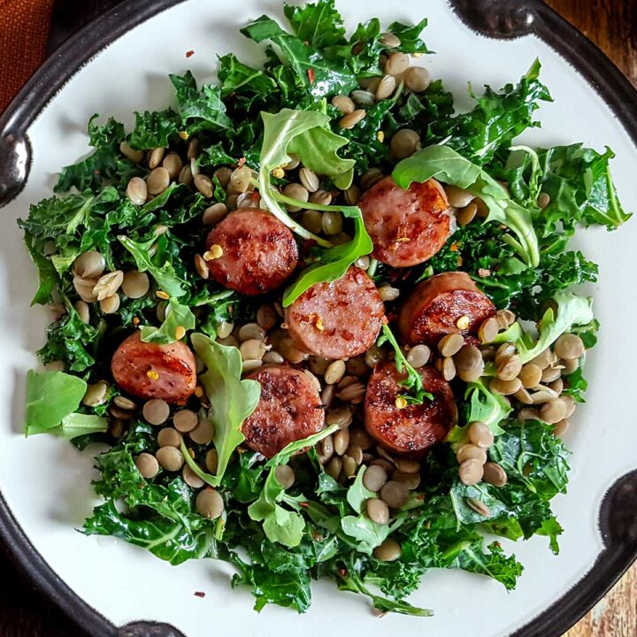 A salad with sausage, kale, and lentils