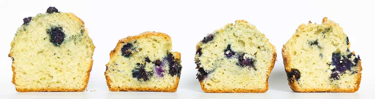 4 blueberry muffins, cut in half, standing in a line