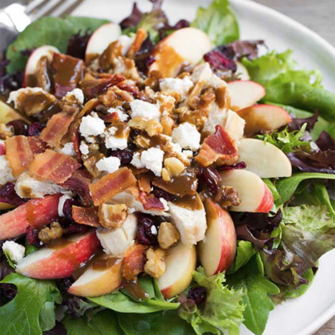 A salad with apples, bacon, feta, and chicken. Recipe by Cooking Classy