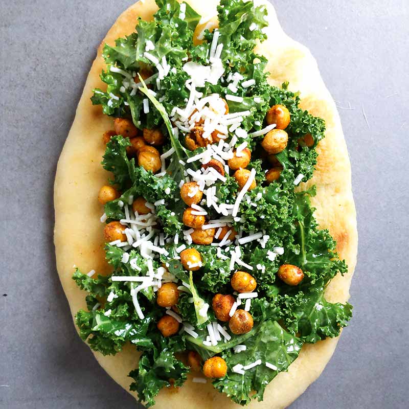 Flatbread topped with a kale caesar salad