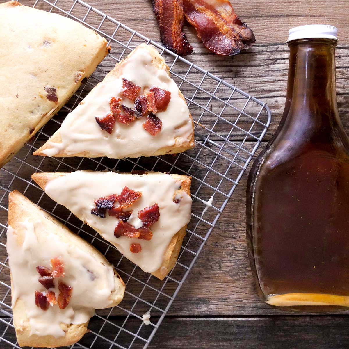 A rack of bacon scones topped with a maple glaze and crumbled bacon