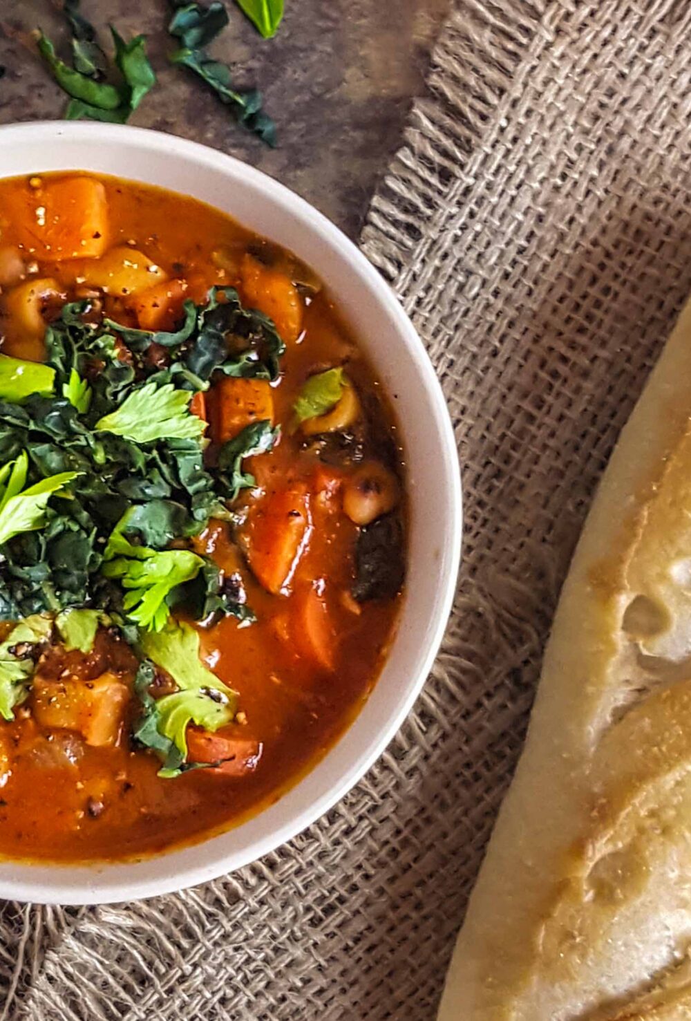 A bowl of minestrone and a side of bread