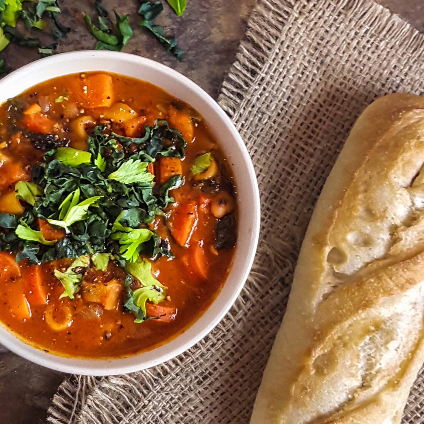 A bowl of minestrone and a side of bread