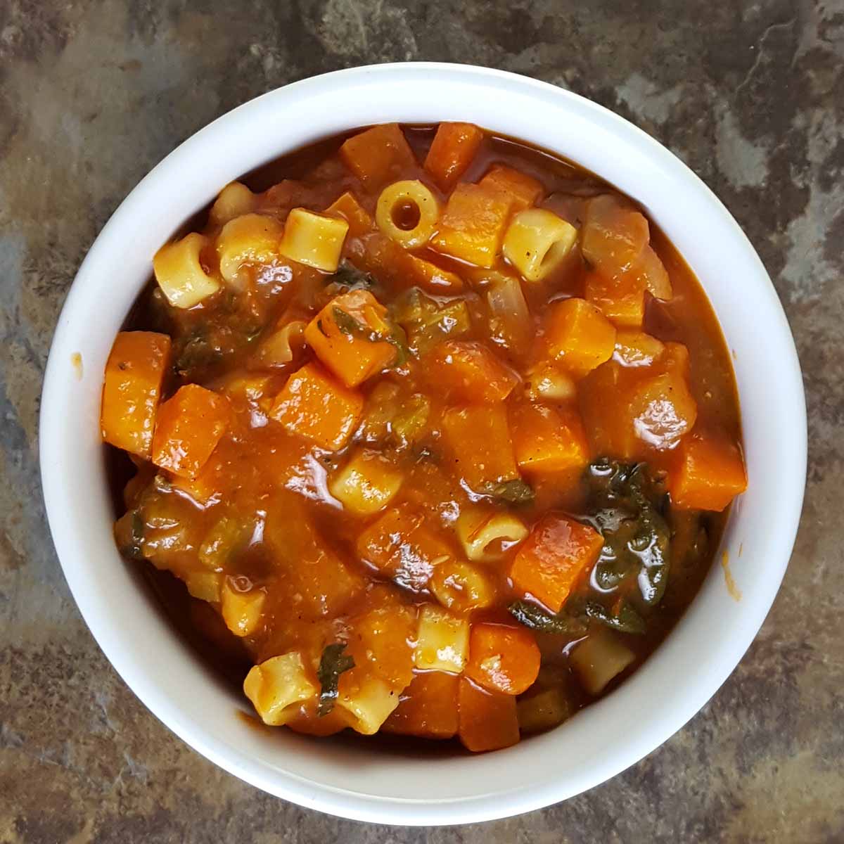 Leftover winter minestrone soup with pasta and vegetables that have absorbed more broth.