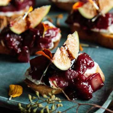 Caramelized cranberry-onion crostini topped with figs, a recipe by Heather Christo