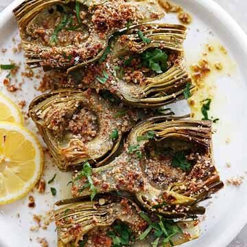 Wine braised artichokes with garlicky pecan bread crumbs recipe by Lexi's Clean Kitchen