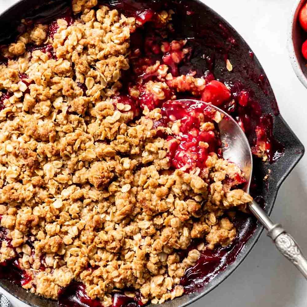A classic cherry crisp with oatmeal topping in a skillet, recipe from House of Nash Eats