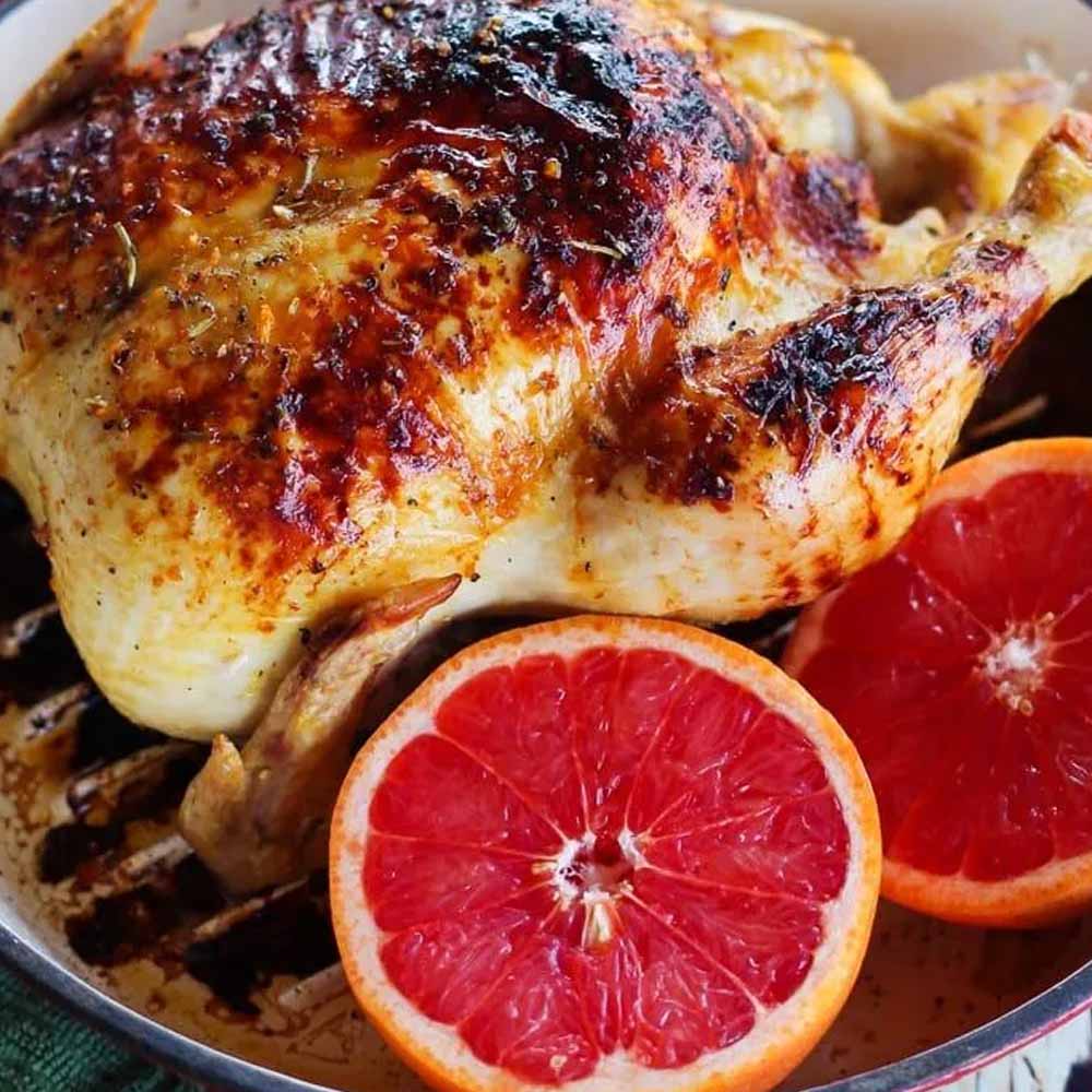 Roasted chicken with grapefruit, honey, and Herbs de Provence. Recipe from Home & Plate