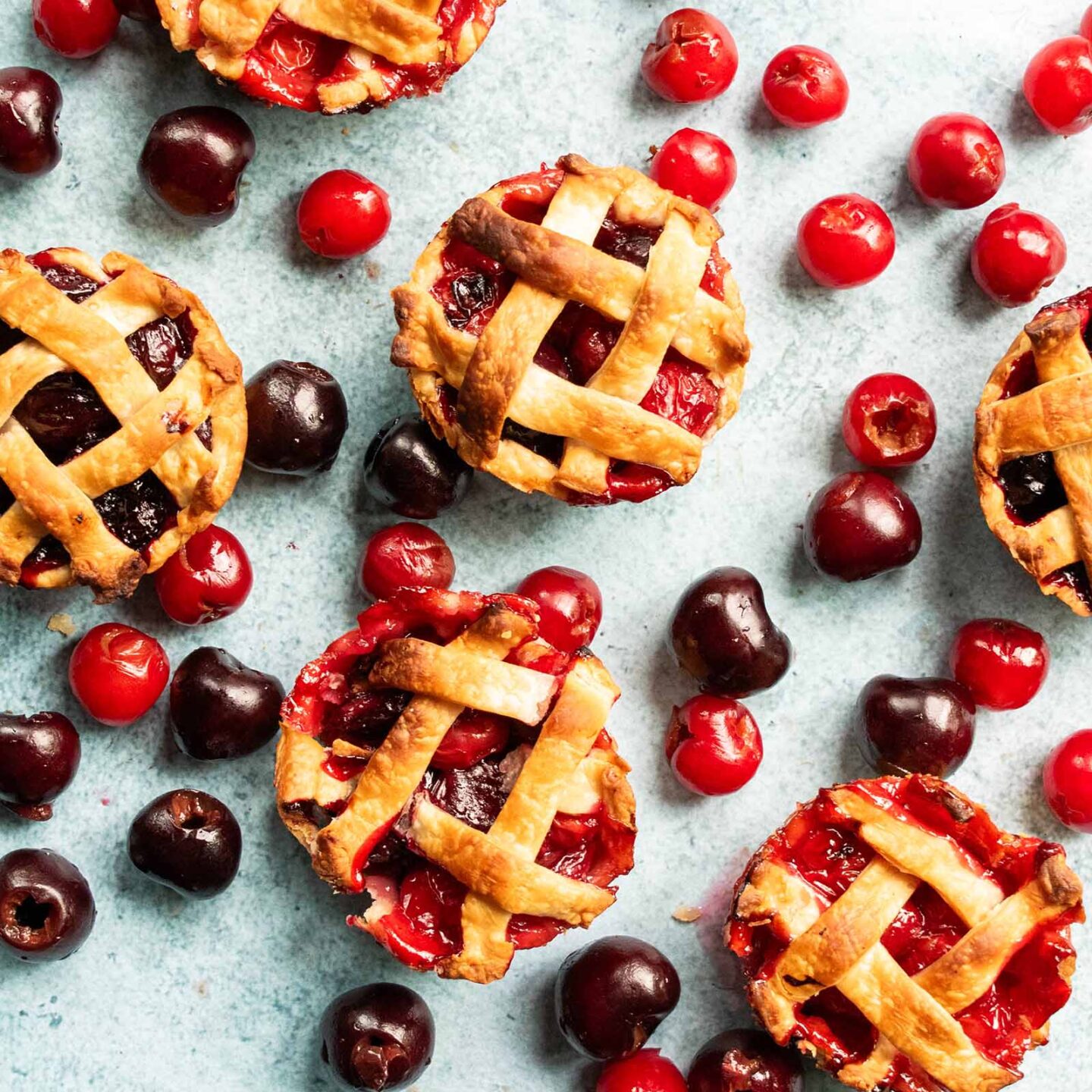 Sweet and sour baked cherry pies on a table.