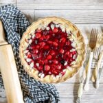 A sour cherry tart with almond cream on a table.
