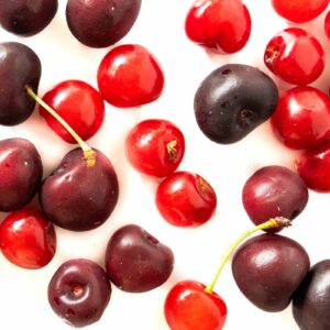 sweet and sour cherries on a table to promote cherry recipes