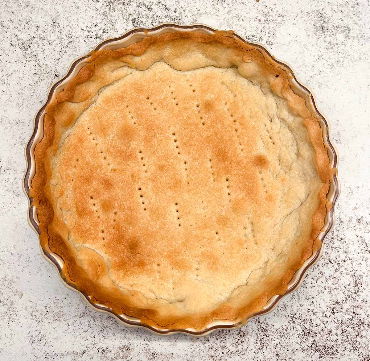 A french-cookie style tart crust after it is baked