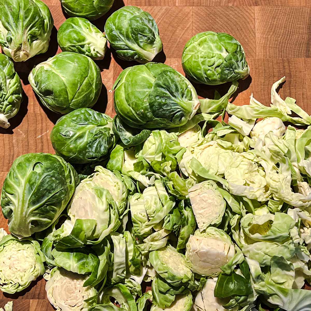 Whole and cut bitter brussels sprouts on cutting board