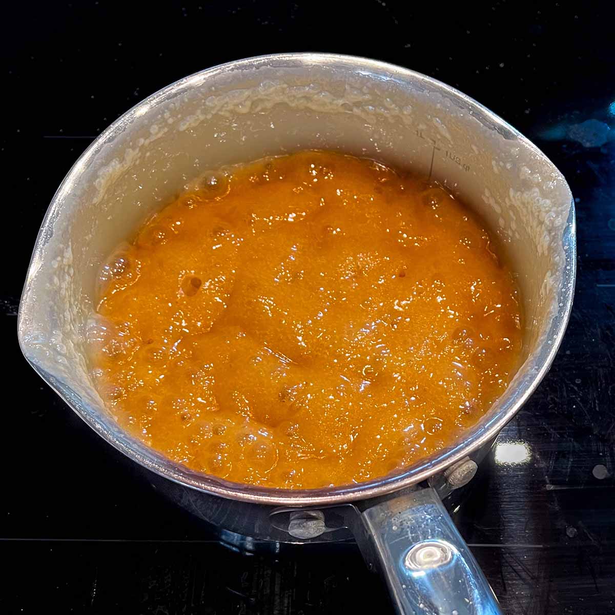 Boiling homemade caramel on the stovetop.