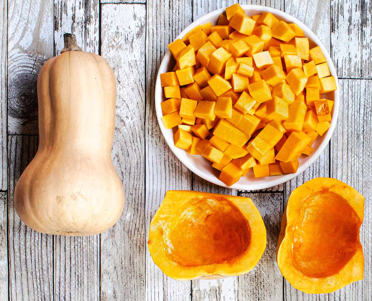 Peeled butternut squash cut in half. The bottom is used for roasting and the top is diced into cubes.