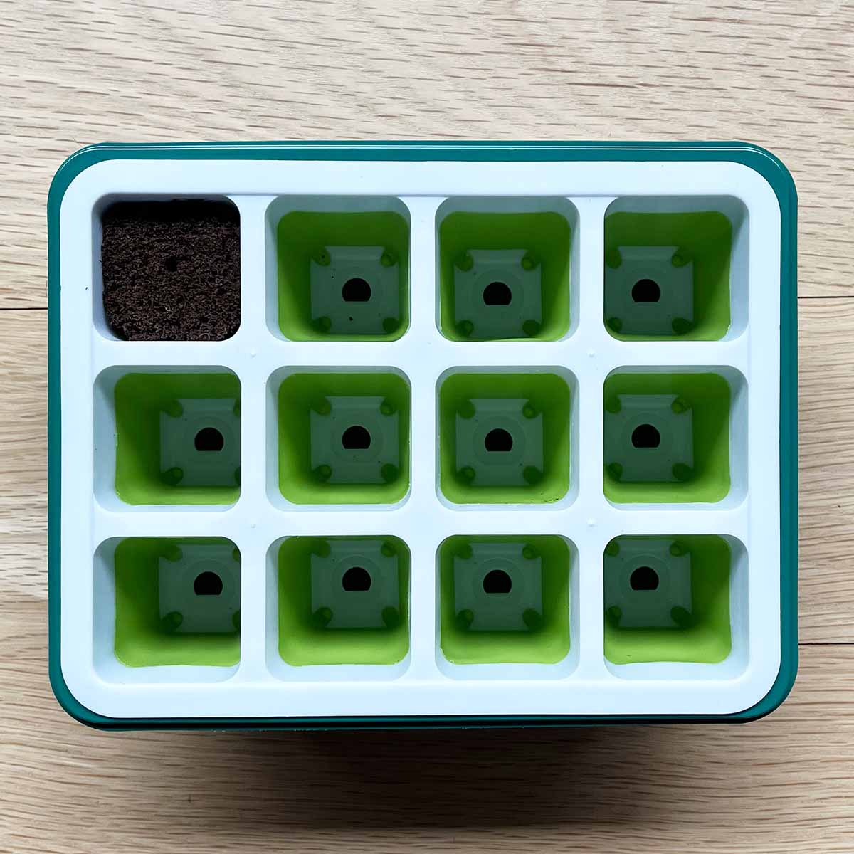 A seed starting tray that I bought and tested, with a soil plug in one slot to show size.