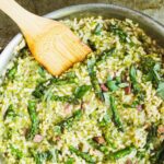 A pan of asparagus risotto with ham mixed in
