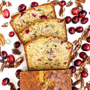 Cranberry nut bread slices with toasted pecans and fresh cranberries