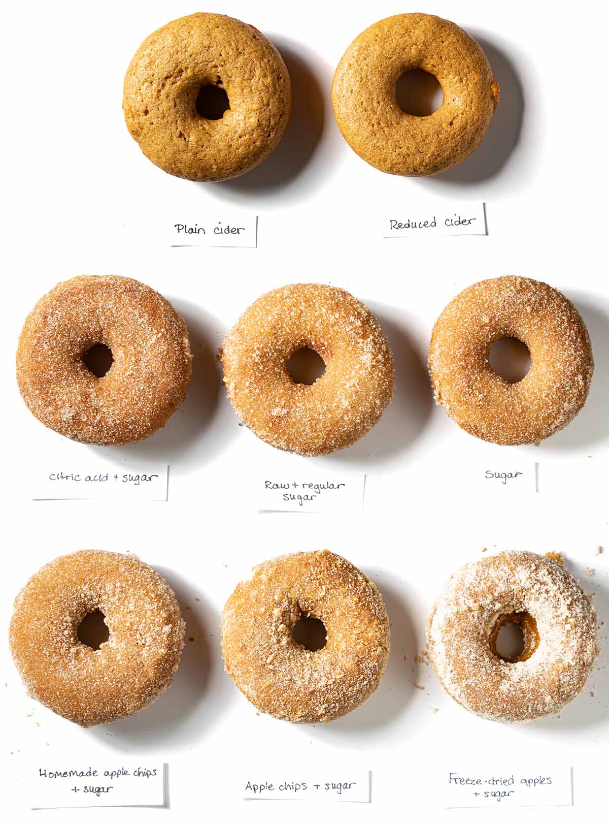 8 baked apple cider donuts variations: plain apple cider, boiled apple cider, citric acid, regular sugar, raw sugar, homemade apple chips, store-bought apple chips, and freeze dried apples.
