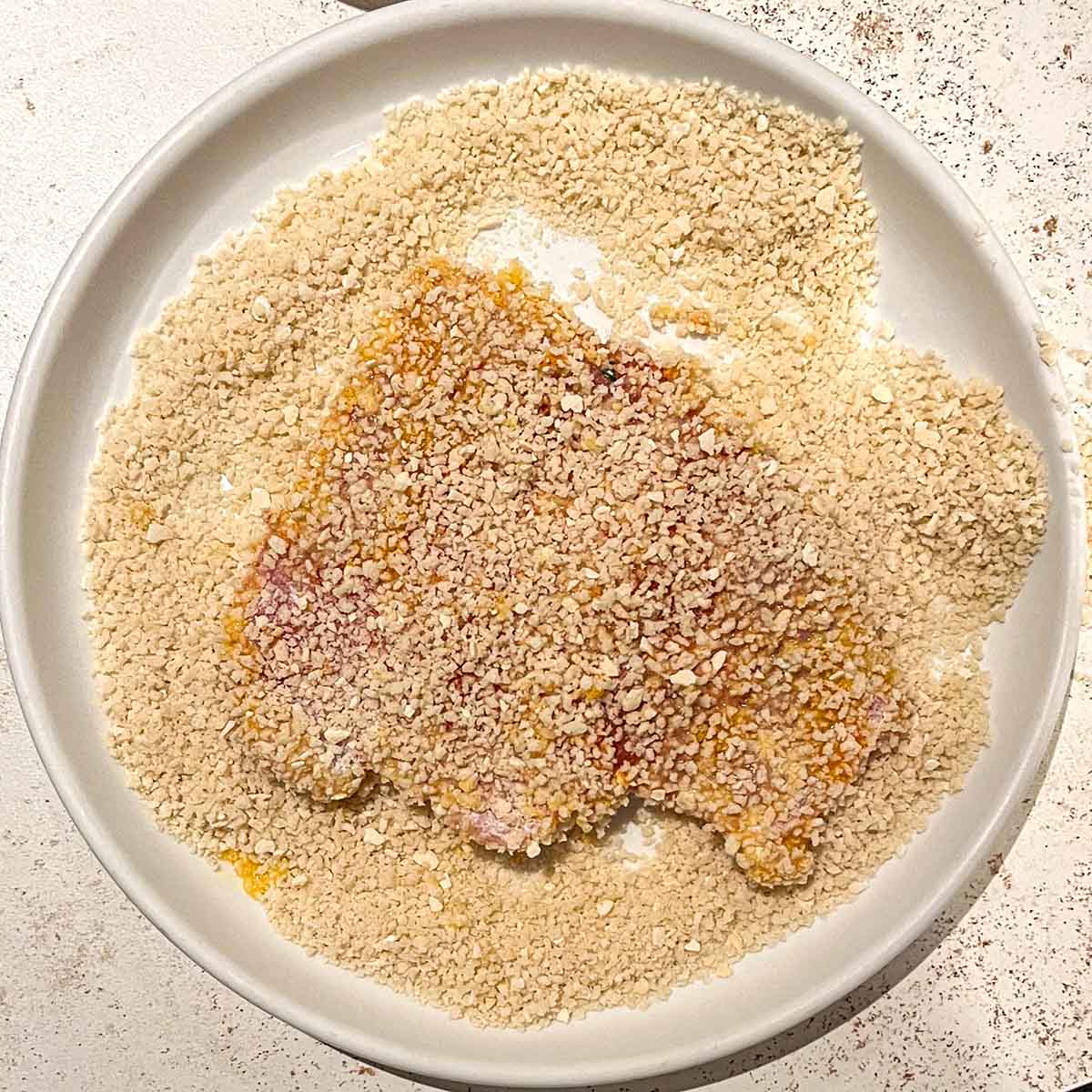 Breading jagerschnitzel, step 3, adding breadcrumbs