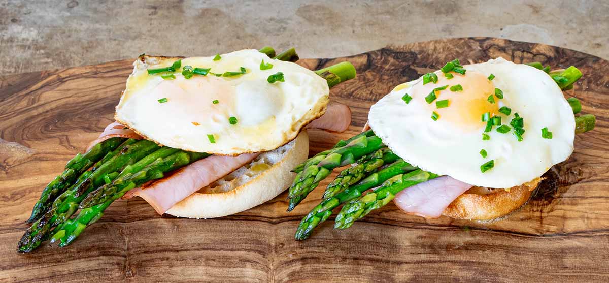 Eggs Benedict on english muffins with asparagus