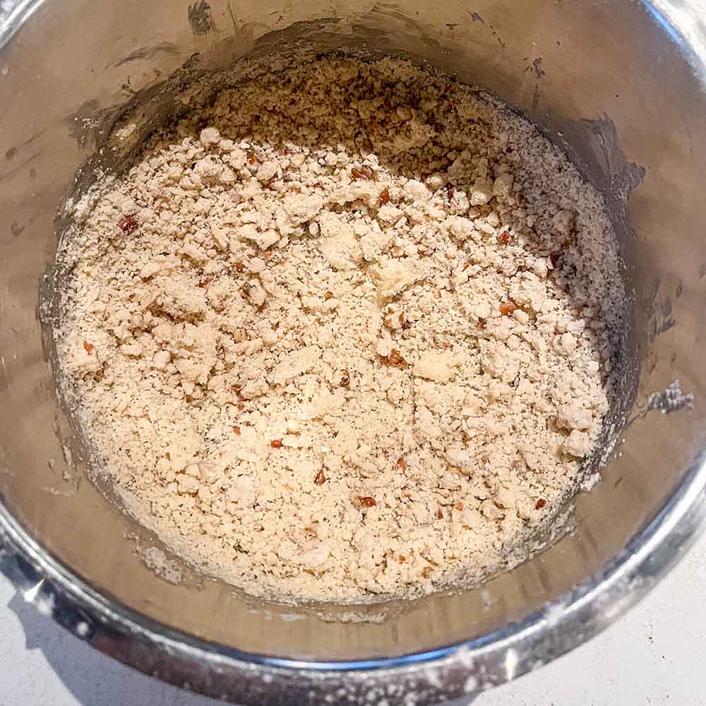 Maple pecan cookie dough in a stand mixer, with a crumbly texture
