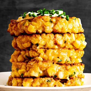 Homemade fresh corn fritters recipe, stacked on a plate