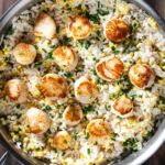 Scallops with risotto and corn in a pan.