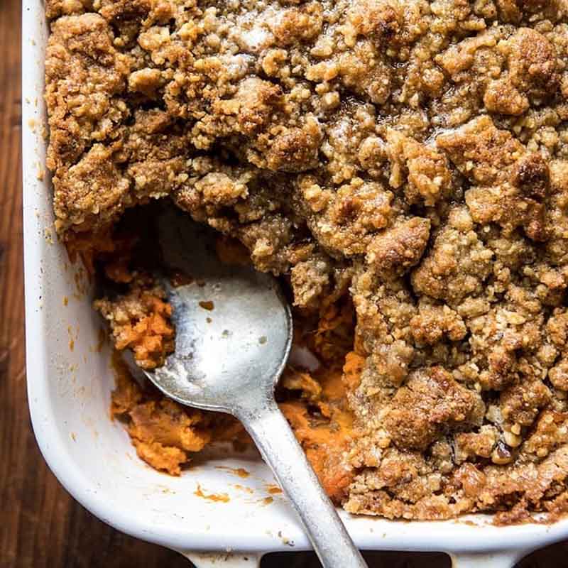 A Thanksgiving sweet potato casserole with a streusel topping, a unique variation as a Friendsgiving food idea alternative.