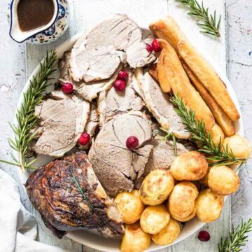 A lamb roast with potatoes and gravy. Recipes for Friendsgiving that aren't turkey. By Recipes from a Pantry.