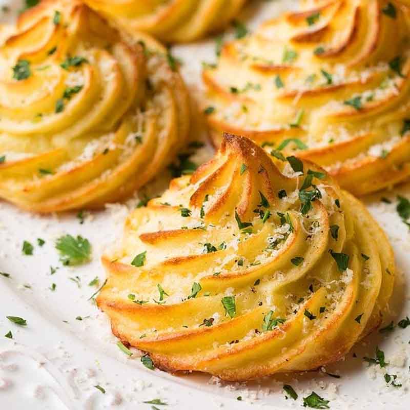 Duchess potatoes topped with parmesan and chives, recipe from Cooking Classy.