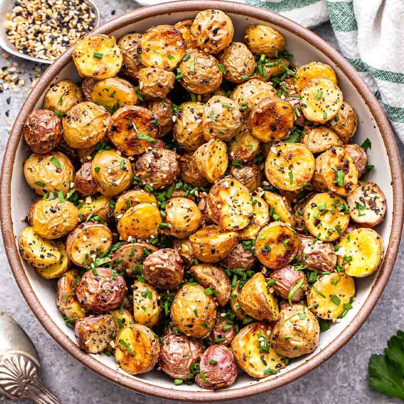 A dish of roasted potatoes topped with everything bagel spice. An alternative recipe for Friendsgiving by Recipe Runner.
