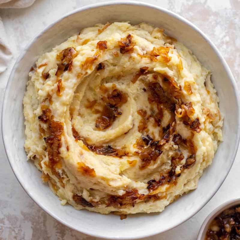 A bowl of French onion mashed potatoes, recipe by How Sweet Eats.