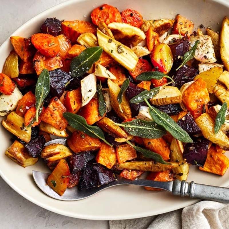 A picture showing how to use fried sage leaves on top of roasted root vegetables. Photo from Love And Lemons.