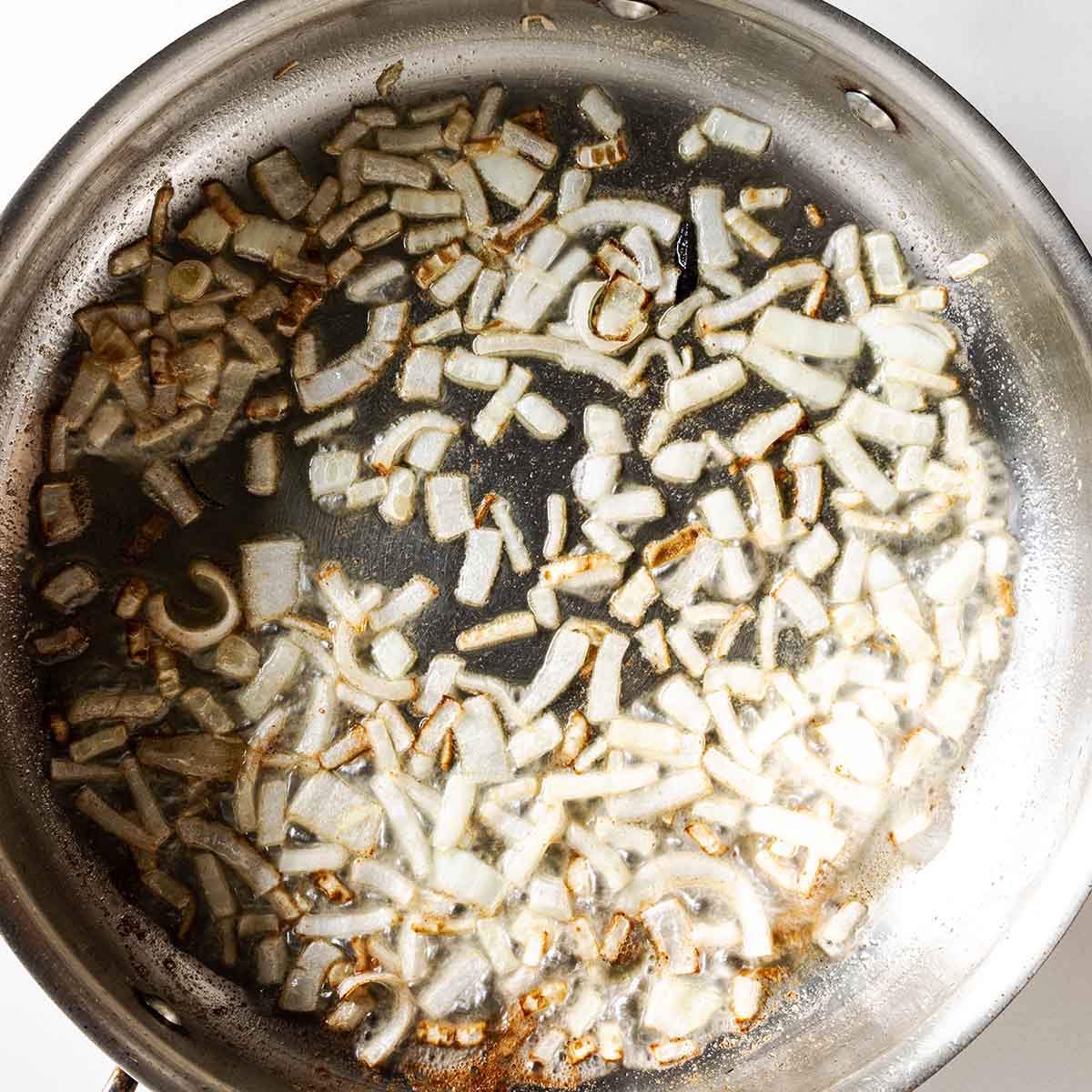 Shallots cooking in a pan, using butter instead of drippings.