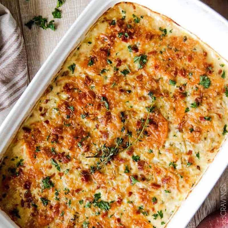 A dish to bring to Friendsgiving filled with make ahead scalloped sweet potatoes. From Carlsbad Cravings.