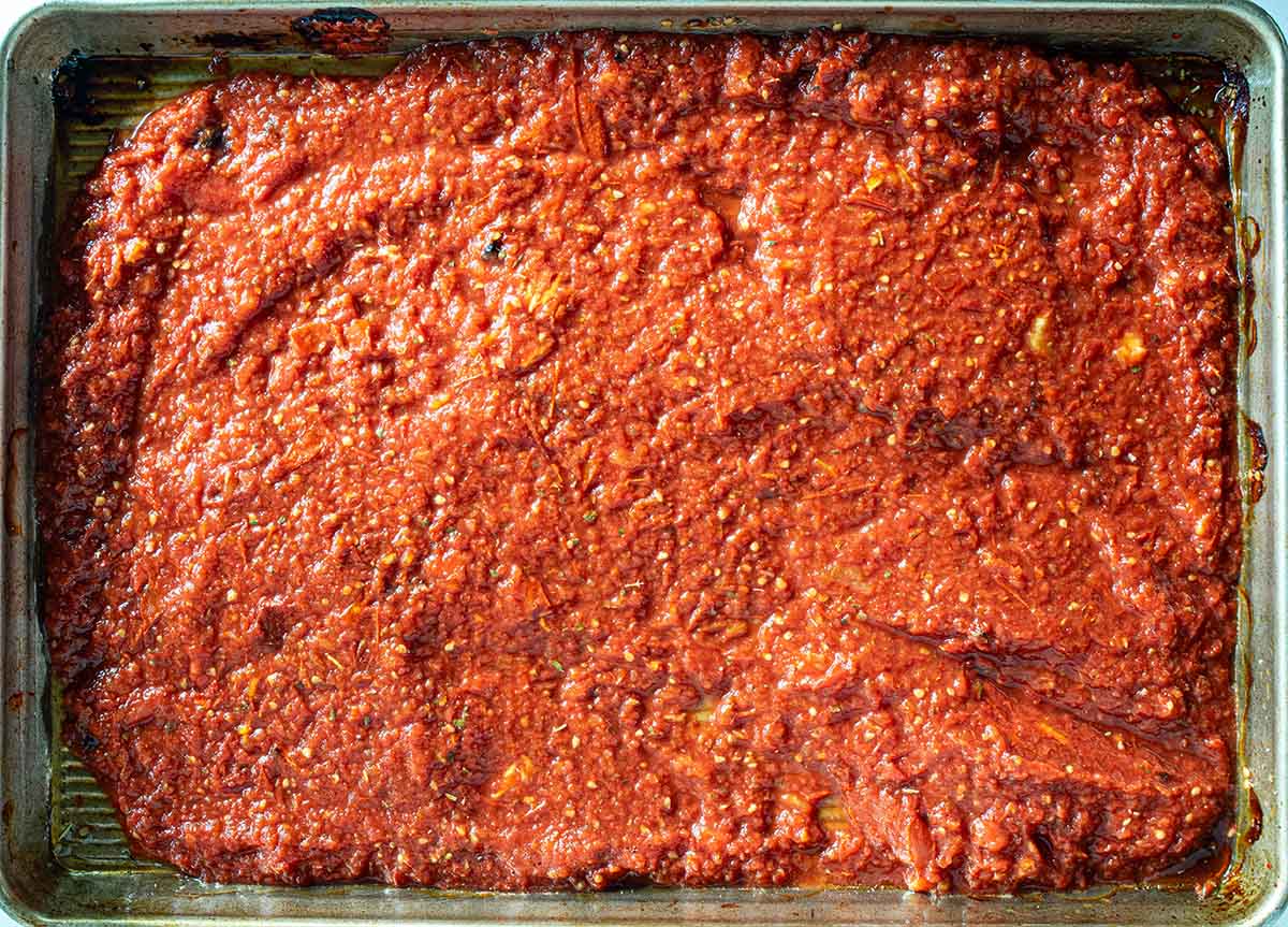 Making pizza sauce with fresh tomatoes by roasting on a tray