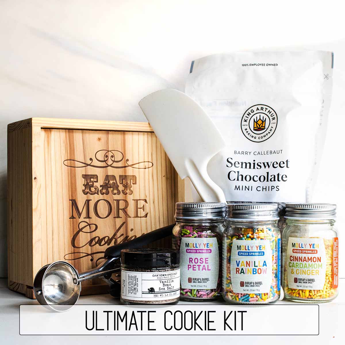 The best baker gift: the ultimate cookie kit includes sprinkles, chocolate chips, vanilla sea salt, chocolate chips, a cookie scoop, and a spatula.