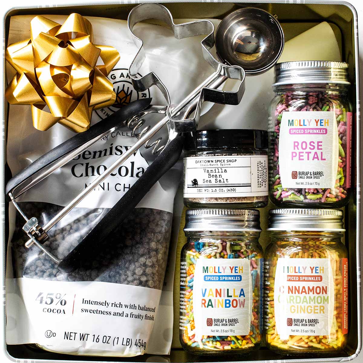 The best gift for bakers: cookie mixins and sprinkles packaged in a cookie tin.