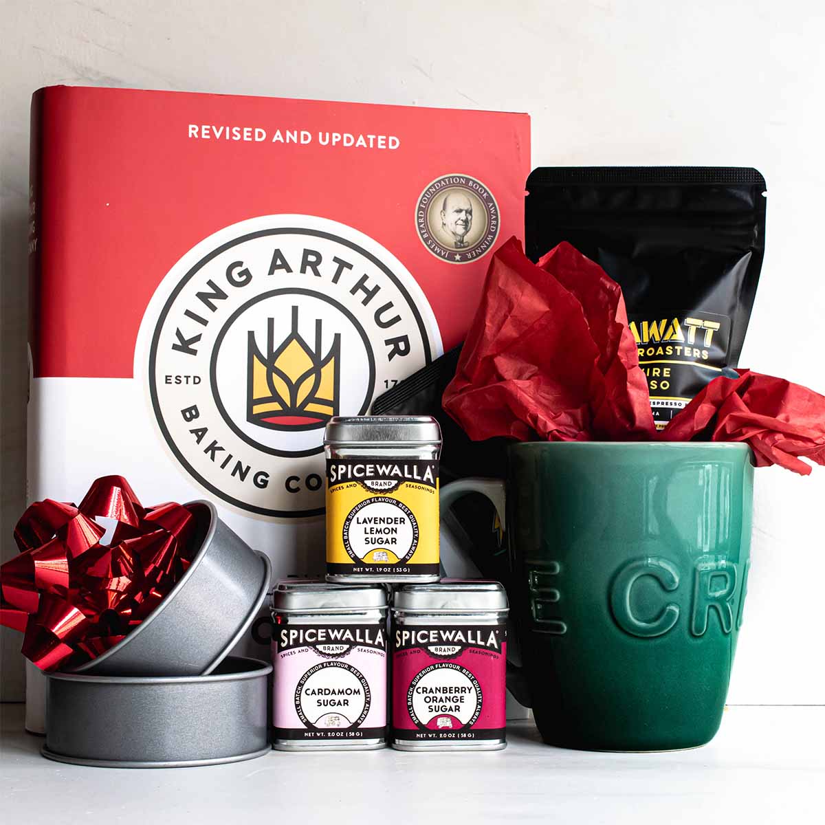 Gifts for bakers: make a kit that includes a cookbook, flavored sugar, a mug, specialty coffee, and english muffin rings for baking her own at home.