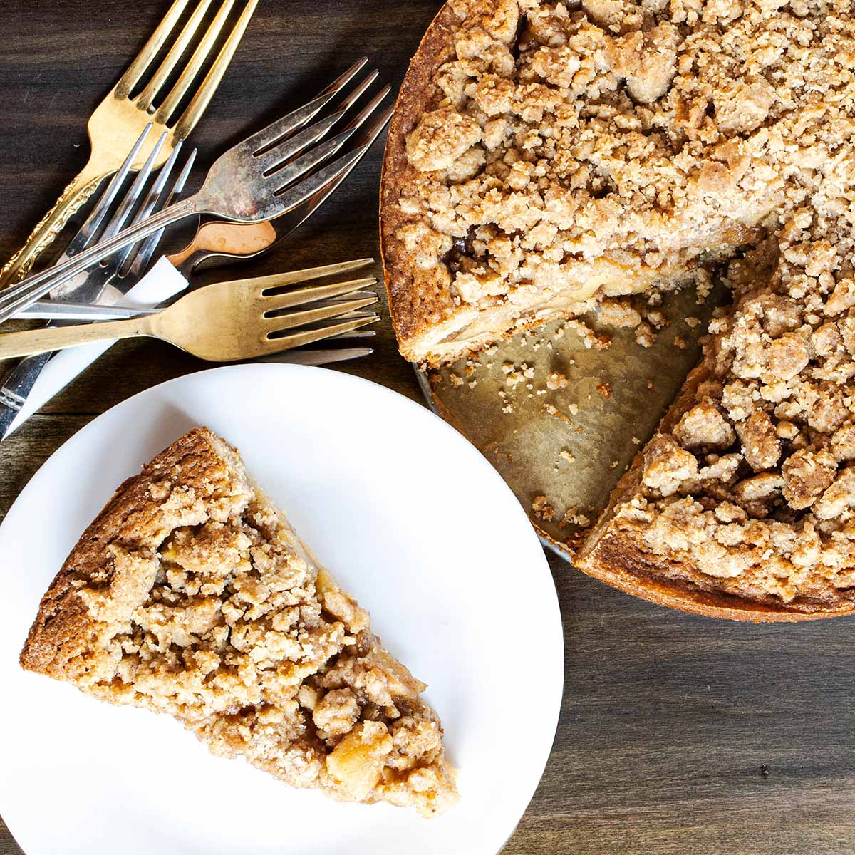 Apple pie for Thanksgiving on a wood table with several forks