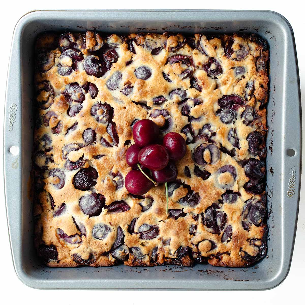 Cherry cobbler topped with fresh cherries