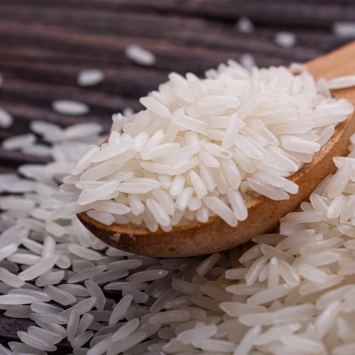 Rice for a stir fry, on a wooden spoon and table