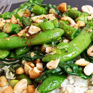 Closeup of a stir fry with asparagus, snap peas, and spinach